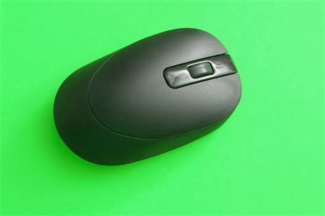 Free Image of Black Wireless Computer Mouse Isolated on Green | Freebie.Photography