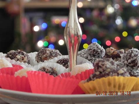 a plate full of desserts with christmas lights in the background