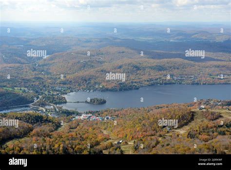 Aerial view of Lake Tremblant and Mont-Tremblant village in fall with fall foliage, from top of ...