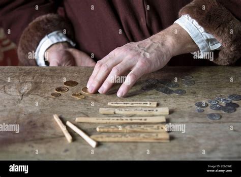 Medieval merchant counting money using tally sticks Stock Photo - Alamy