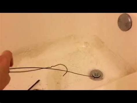 How to unclog a drain with a coat hanger - YouTube