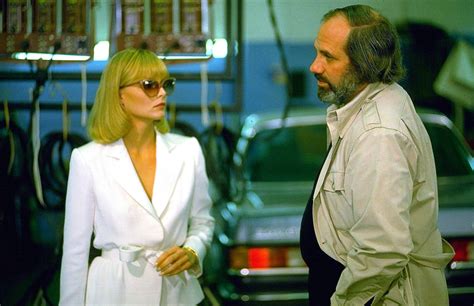 Michelle Pfeiffer talks with director Brian DePalma on the set of "Scarface", 1983. Producer ...