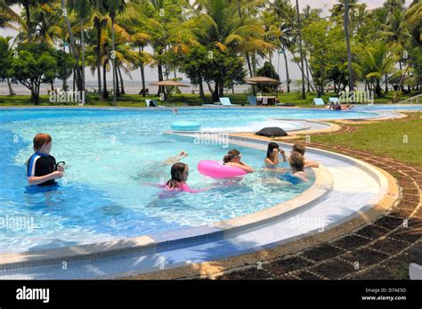 Children in swimming pool CGH Earth Coconut Lagoon resort, Kerala, India Stock Photo - Alamy