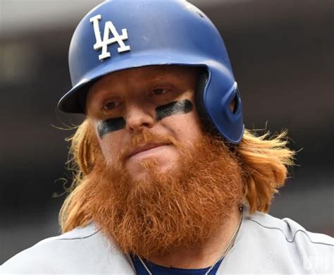 Los Angeles Dodgers Justin Turner sports his long hair and beard as he warms up in the fourth ...