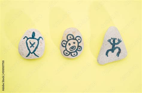 Stones with hand-drawn taino petroglyphs symbols, craft with children for Hispanic heritage ...