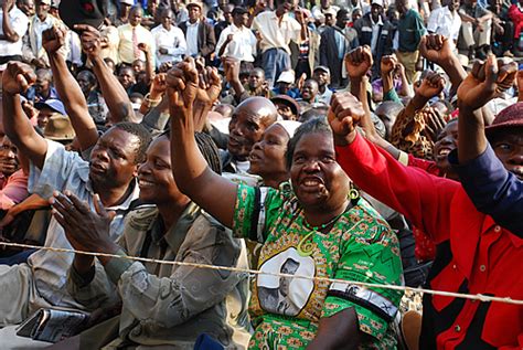 ZANU PF supporters chant slogans as they listen to an address by ...