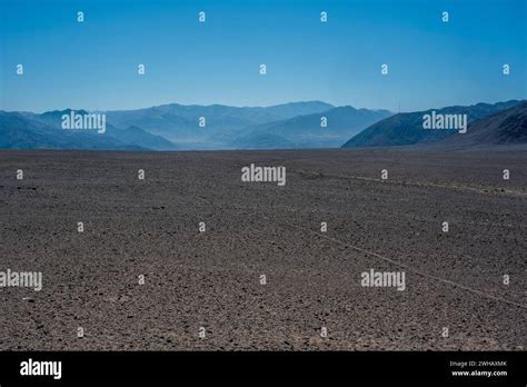 blue sky and brown desert in the rocky highlands near Nazca with desert ...