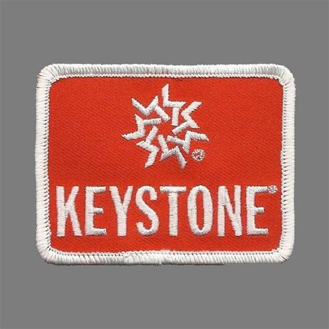 a red and white patch with the words keystone on it