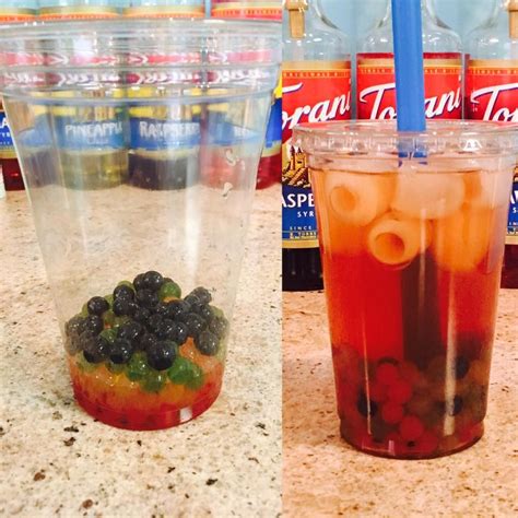 two cups filled with drinks sitting on top of a counter