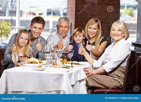 Family in Restaurant Holding Thumbs Stock Image - Image of parentsinlaw ...