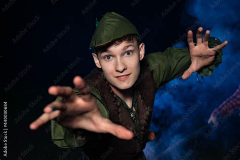 Cosplay on Peter Pan. A young man in a Peter Pan costume stands amid ...