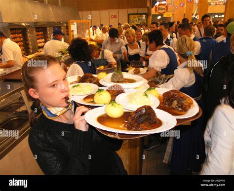 Server waitress carry tray of roasted chicken or roasted meat around Stock Photo: 5059220 - Alamy