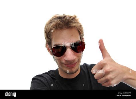 Young man giving a reassuring smile wearing aviator sunglasses isolated ...