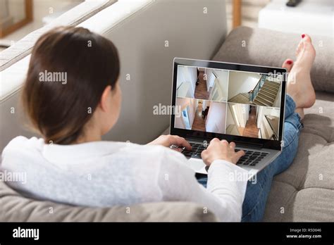 Woman Monitoring CCTV Footage On Laptop Stock Photo - Alamy