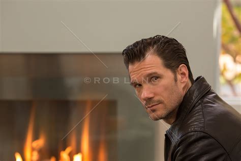 man near a modern fireplace | Rob Lang Images