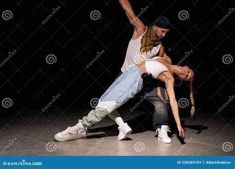 Modern. Fashionable Couple Dancing Hip-hop in Stylish Clothes on Black Background Stock Image ...