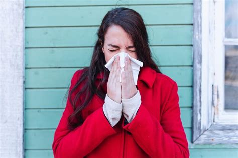 Premium Photo | Woman blowing her nose with a tissue