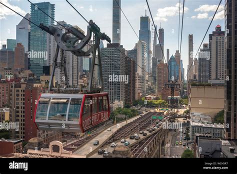 Roosevelt Island Tramway, aerial view of a tram car passing East 60th ...