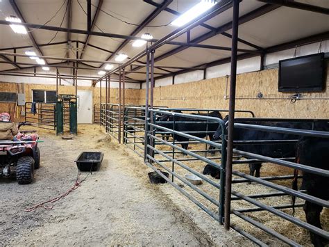 At an angle, the stalls can be divided by small wooden walls/fences. Reindeers could be in the ...