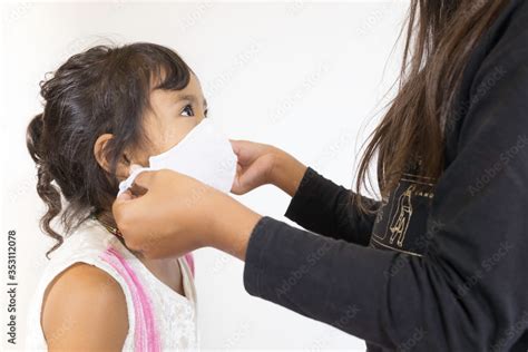 An image of a preschool sister wearing a mask worn by an older sister ...