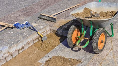 Tool for laying paving slabs on a background of granite bricks and sand ...