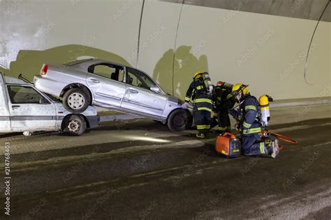 Car accident scene inside a tunnel, firefighters rescuing people from ...