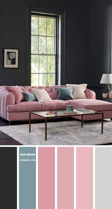 a living room with black walls, pink couch and gray rugs on the floor