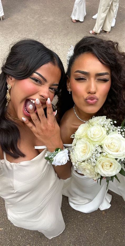 two brides are posing for the camera with their wedding rings