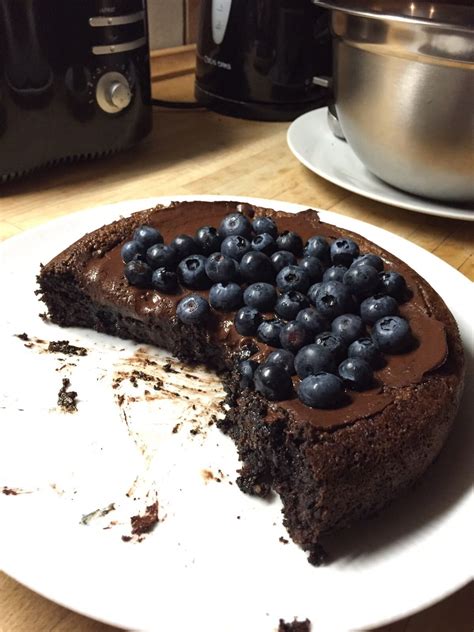 a piece of chocolate cake with blueberries on it