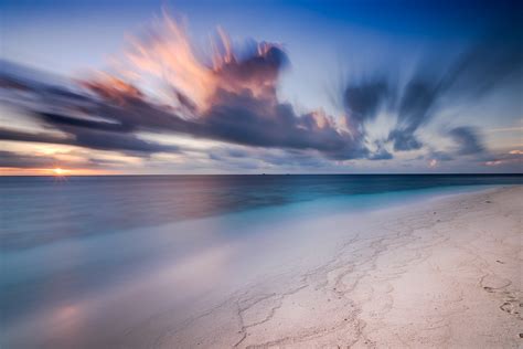 Beach sunrise in the Maldives, captured by landscape photographer, Jennifer Esseiva. | Behance