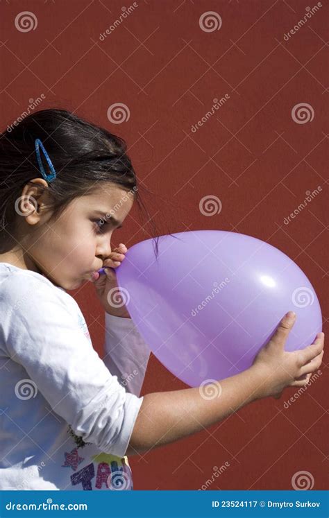 Girl blowing up balloon stock image. Image of cheerfulness - 23524117