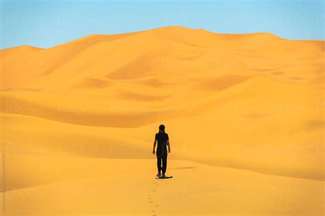 Man Walking On A Dunes In Desert. | Stocksy United