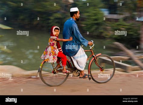 A group of Bangladeshi people traveling by bicycle from the countryside ...