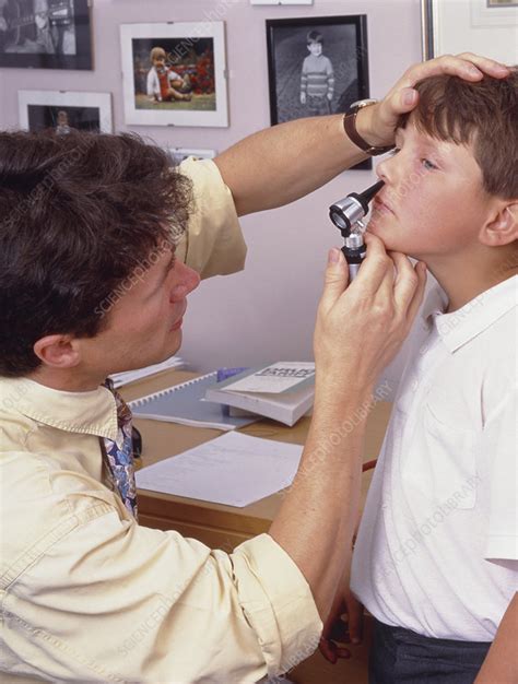 Doctor examines boy's nose with otoscope - Stock Image - M825/0424 ...