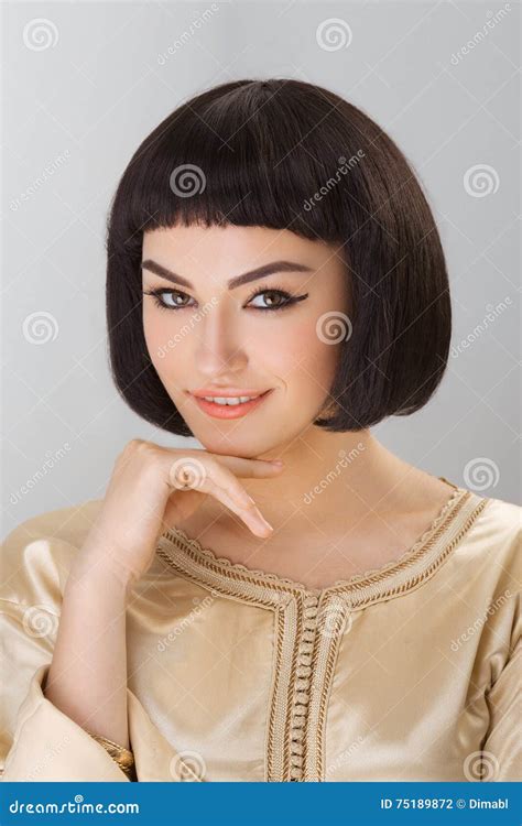 Smiling Girl with Cleopatra S Make-up and Haircut Posing in Studio ...