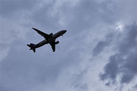 White Airplane Under White Clouds · Free Stock Photo