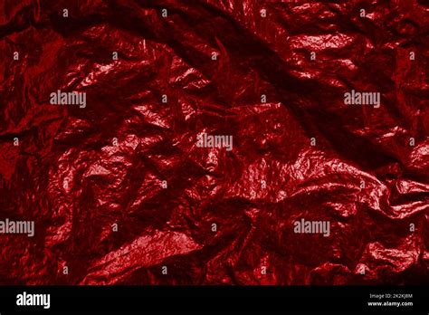 Crumpled red foil background texture with light reflection Stock Photo - Alamy