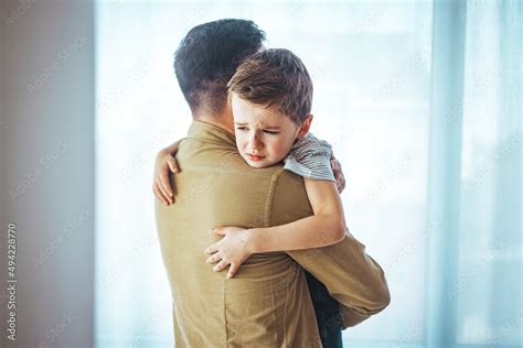 Portrait of a crying child on hands a father. Little boy crying on ...