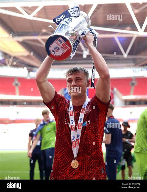 Carlisle United's Owen Moxon celebrates with the trophy after being ...