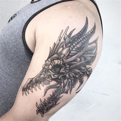 a man with a dragon tattoo on his arm