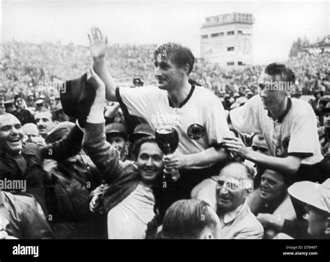 German soccer player Fritz Walter, (C, holding the cup in his hands ...