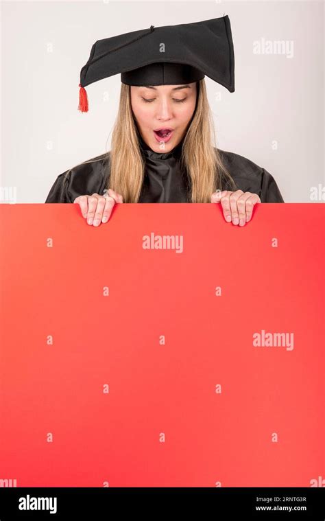 Surprised graduate holding red placard mock up Stock Photo - Alamy