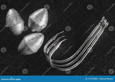 Fishing Equipment: Hooks and Fishing Sinkers on a Dark Stock Photo ...