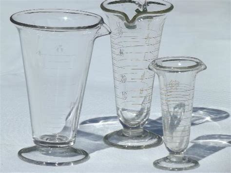 old antique lab glass beakers, graduated size pharmacy bottle measures