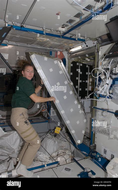 ISS-18 Sandra Magnus works on a crew quarters compartment in the ...