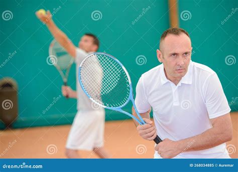 Men playing doubles tennis stock image. Image of sportsman - 268034885