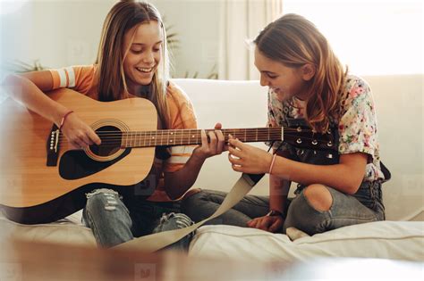 Girls learning to play guitar stock photo (167658) - YouWorkForThem