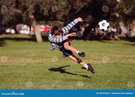 Boy Kicking Soccer Ball Stock Photo - Image: 28393660