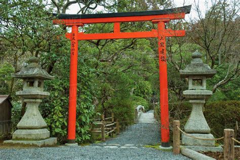 Red and black torii gate in a japanese temple garden;Kyoto japan - Stock Photo - Dissolve