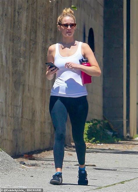 Jennifer Lawrence shows off her toned physique in white tank top and black leggings in Los ...